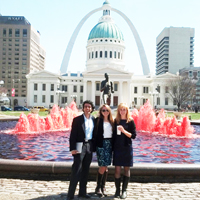 The AidData team stands in front of St. Louis' iconic arch.